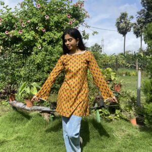 Bright mustard yellow kurti with all-over print and stylish straight fit