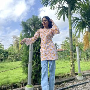 White base kurti with yellow floral motifs, straight cut and bell sleeves